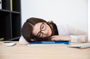 Beautiful businesswoman sleeping at the table in office